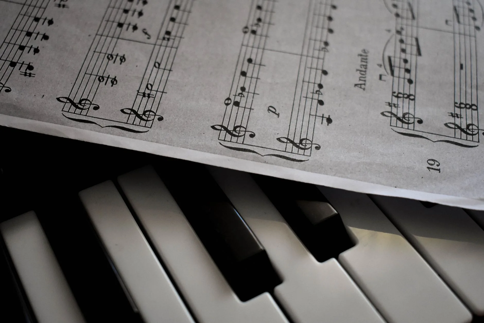 Teen singer practicing in a spacious, softly lit rehearsal room, belting music technique.
