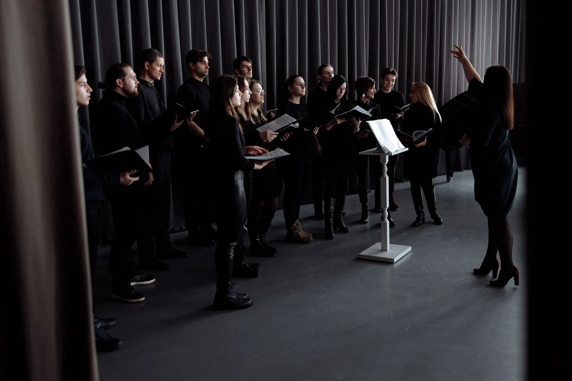 Grand rehearsal space with high ceilings, supporting choir history." (16 words)