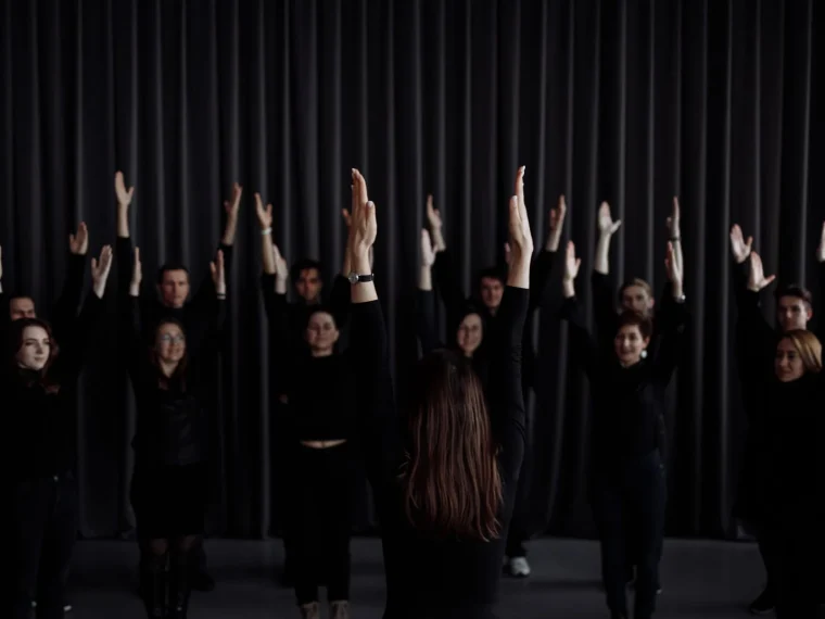 Matthew Quinn conducting New London Children's Choir in soft, muted lighting.